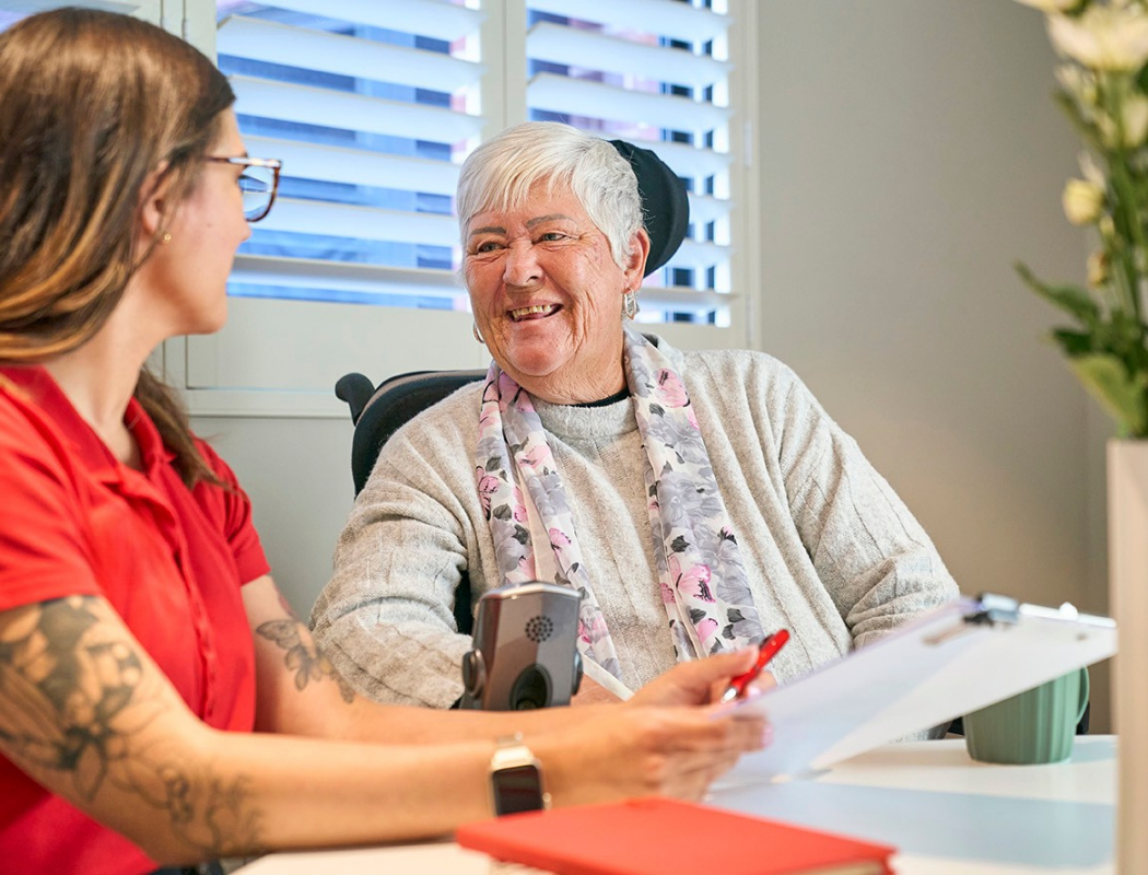 client and staff speaking and smiling