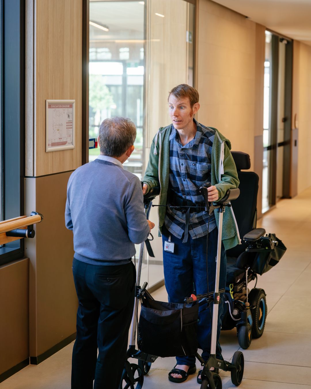 client with a health professional using a walking aid