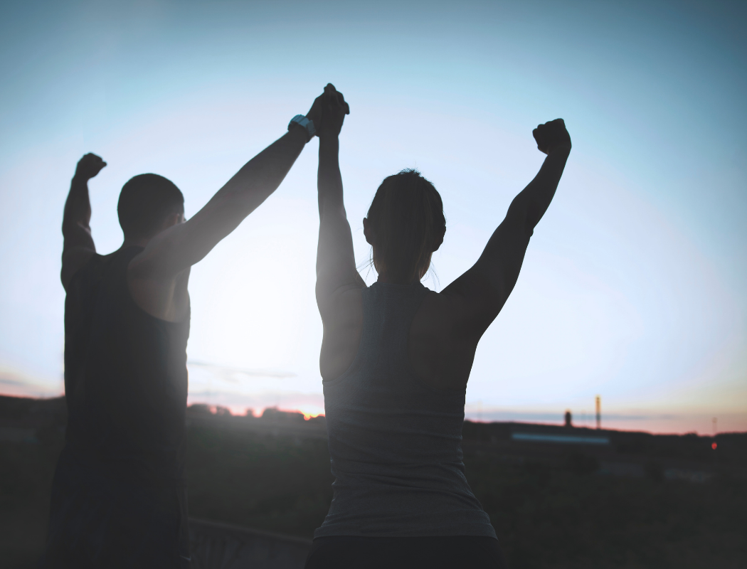 Two people with their arms in the air.