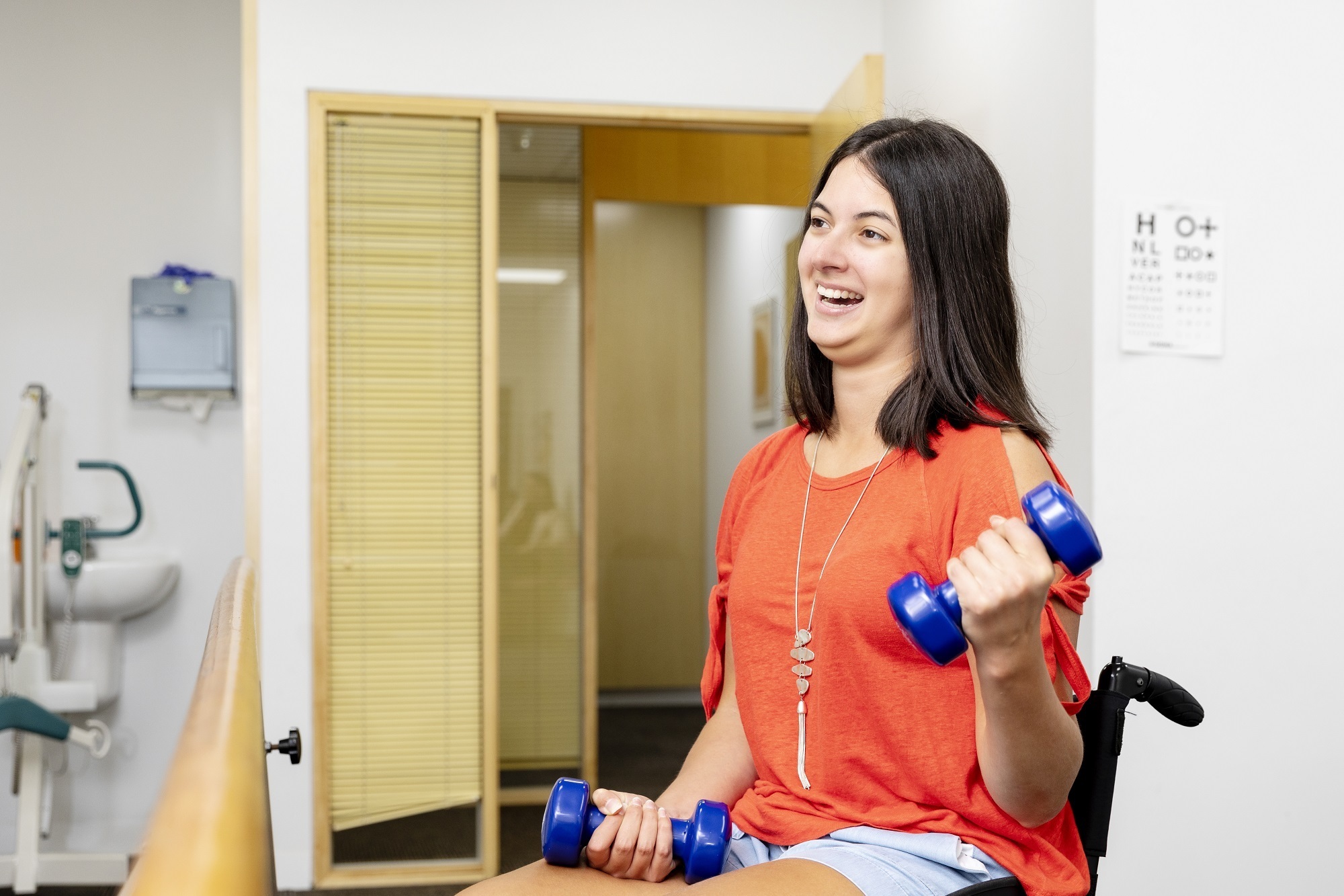 Girl holding blue weights