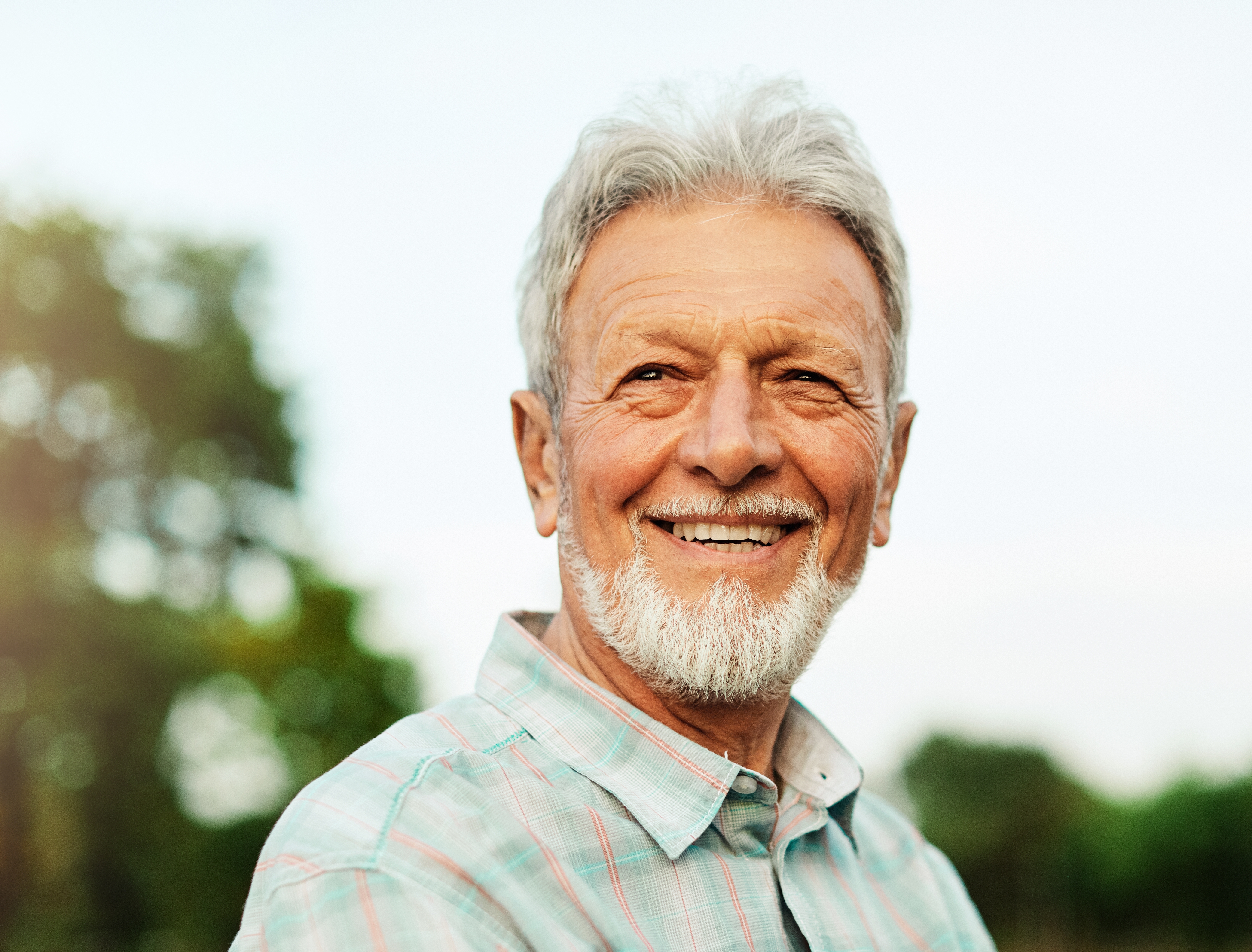 Portrait of elderly man outdoors.