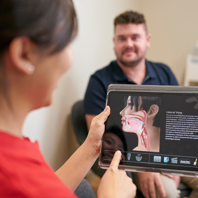 speech pathologist with client during session