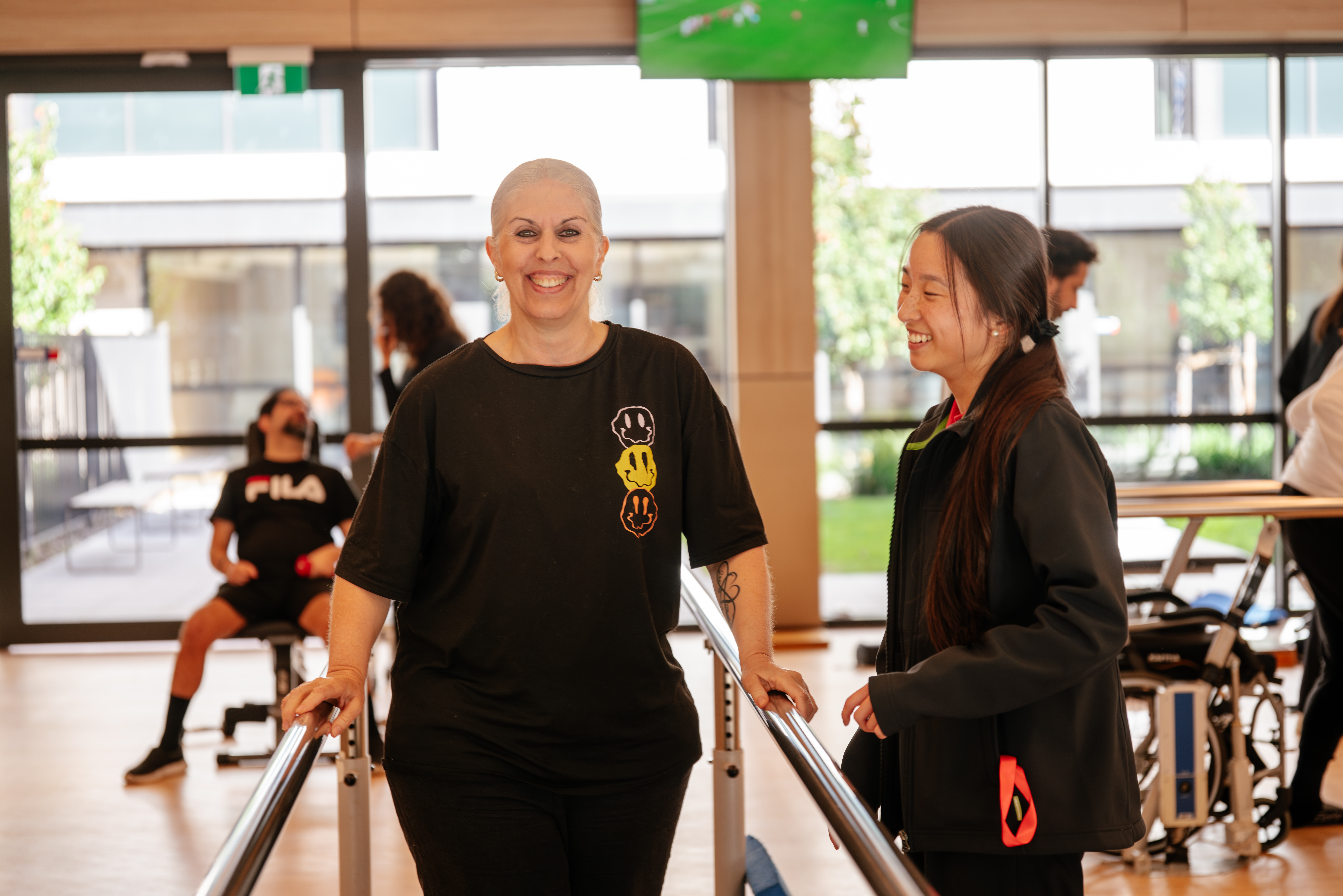 client in the lidcombe wellbeing gym wearing black with a health professional