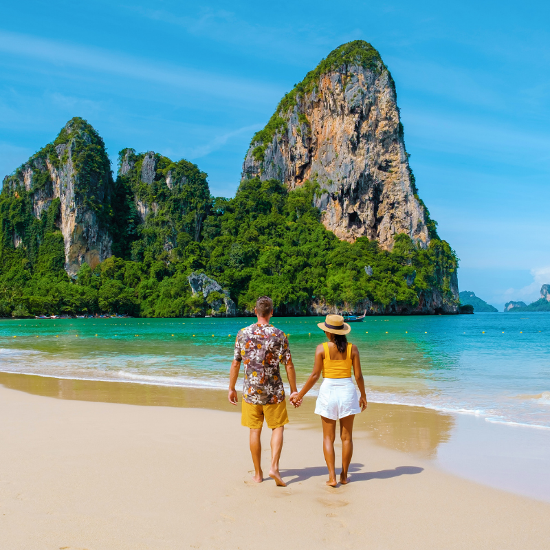 people walking on a sandy beach